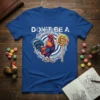 Blue t-shirt with "Don't Be A Chicken" text, a colorful rooster, and a lollipop graphic