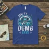 Fishing t-shirt with "Don't Be A Dumb Bass" text and a graphic of a bass fish with a fishing rod