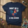 Don't Be A A Coq-Sucker text with a colorful rooster holding a lollipop graphic on a navy t-shirt