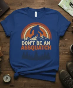 Don't Be An Assquatch Bigfoot T-Shirt with vintage sunset and mountain graphic