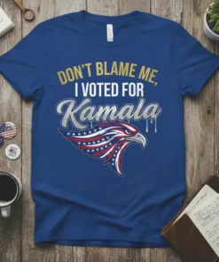 Blue t-shirt with gold and silver text reading "DON'T BLAME ME, I VOTED FOR Kamala" above a patriotic eagle graphic