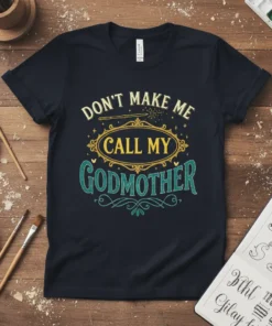 Don't Make Me Call My Godmother text design with a magic wand and decorative elements on a navy t-shirt
