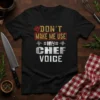 Black t-shirt with "Don't Make Me Use My Chef Voice" text in distressed yellow, red, and white typography, featuring a