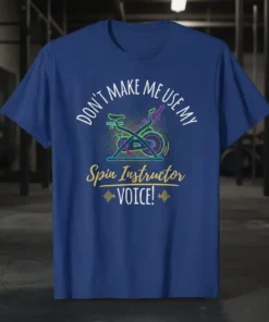 Don't Make Me Use My Spin Instructor VOICE text with a neon spin bike graphic on a blue t-shirt
