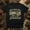 T-shirt with "Don't Mess With Grandmasaurus You'll Get Jurasskicked" text and a dinosaur skull graphic