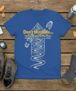 Blue t-shirt with "Don't Mind Me... I'm Just Getting My Steps" text and a mountain trail graphic