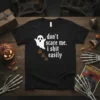 Black t-shirt with white gothic font text "don't scare me. i shit easily" and a cartoon ghost dropping brown poop