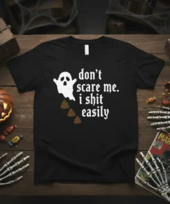 Black t-shirt with white gothic font text "don't scare me. i shit easily" and a cartoon ghost dropping brown poop