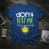 Blue t-shirt with white and green text "don't TEST ME I have screenshots" and a yellow shield emoji graphic