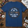Blue t-shirt with "DON'T WORRY, MY TATTOOS DON'T LIKE YOU EITHER" text inside a barbed wire circle, featuring skulls