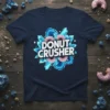 Donut Crusher text with pink donuts and blue crystals graphic on a navy t-shirt