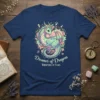 Dreamer of Dragons Whisperer of Stars text with a pastel dragon and floral design on a navy t-shirt