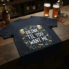 Navy blue t-shirt with "Drink 'Til You Want Me" text surrounded by cocktail and beer graphics