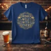Navy blue t-shirt with gold text "Drinks Well With Others" and graphics of beer mugs and hops