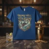 T-shirt with "Drinks Well With Others" text and martini glass graphic in a decorative shield