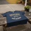 Driveway Drinker t-shirt featuring text and two wine glasses graphic in gold and white distressed design
