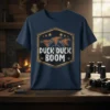 Duck Duck Boom graphic t-shirt with three flying ducks and target crosshairs, designed for hunters