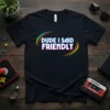 Dude I Said Friendly text design on a black t-shirt, featuring retro neon-style lettering and curved lines