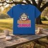 Dunkie Junkie text design with a coffee cup topped with whipped cream and surrounded by donuts, on a blue t-shirt