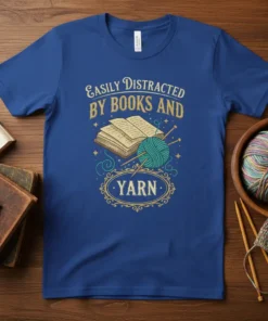 Easily Distracted By Books And Yarn text with an open book and teal yarn on a royal blue t-shirt