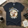 Easily Distracted By Cows funny cow t-shirt with a watercolor cow graphic and gold circle border