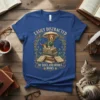 Easily Distracted By Dogs And Books Books text on a blue t-shirt with a beagle dog sitting on books under