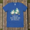Easily Distracted By Ducks text with illustration of ducks on a blue t-shirt