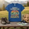 Easily Distracted By Goats t-shirt featuring three goats on a sunset background with distressed typography
