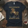 Easily Distracted by Horses & Book quote on a navy t-shirt featuring a horse made of books