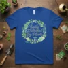 Easily Distracted By Plants quote in script font surrounded by a floral wreath on a royal blue t-shirt