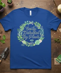 Easily Distracted By Plants quote in script font surrounded by a floral wreath on a royal blue t-shirt