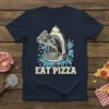 Shark with open mouth eating a slice of pizza, with the text "EAT PIZZA" below, on a navy t-shirt