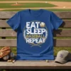Eat Sleep Baseball Repeat text design with baseball graphic and crossed bats on a blue t-shirt