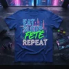 Eat Sleep FETÉ Repeat t-shirt with neon cityscape graphic, blue shirt, white and green text