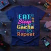 Eat Sleep Gacha Repeat text design on a navy t-shirt with pixelated graphics and game-related icons