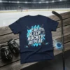 Eat Sleep Hockey Repeat text design on a navy blue t-shirt with hockey helmet and crossed sticks graphic
