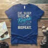 Eat Sleep Sleep Kayak Repeat T-Shirt with graphic of kayaker, mountains, and sun