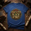 Educated Black King text in gold metallic font on a royal blue t-shirt, with ornate circular border design