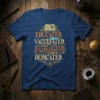 Educated Vaccinated Caffeinated Dedicated quote on a blue t-shirt, featuring a book, syringe, and coffee cup graphic