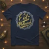 Eid Mubarak text in gold and silver calligraphy on a navy t-shirt, featuring a circular geometric design with a moon