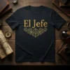El Jefe Spanish text with ornate gold flourish on a black t-shirt, representing leadership and pride