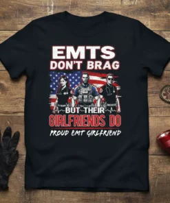 Proud EMT girlfriend t-shirt with text "Emts Don't Brag But Their Girlfriends Do" and graphics of EMTs and American flag