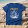 Christian t-shirt with golden text "EVEN THE WIND AND WAVES OBEY HIM MARK 4:41 Be Still" above a beach scene