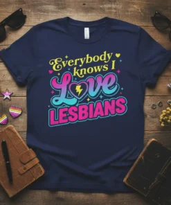 Everybody Knows I Love LESBIANS text design with a heart and lightning bolt, rainbow colors, on a navy t-shirt