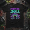 Black t-shirt with "EVERYTHING HURTS AND I AM DYING" text and a neon digital rainbow graphic
