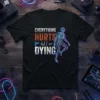 Everything Hurts And I Am Dying skeleton graphic t-shirt with neon outline, humorous quote about pain