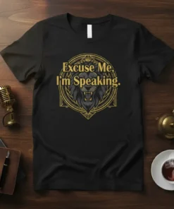 Black t-shirt with gold text "Excuse Me, I'm Speaking" above a fierce lion graphic in a decorative circle