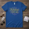 Blue t-shirt with "Fabulous SQUAD" in gold glittery font, surrounded by pink and gold bursts and stars