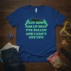 Blue t-shirt with neon green text "FACE DOWN ASS UP HELP I'VE FALLEN AND I CAN'T GET UP!!!" and a