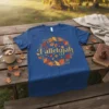 Blue t-shirt with "Falleujah" text surrounded by a decorative wreath of red, orange, and yellow autumn leaves and acorns